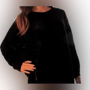 Black knit sweater with slit sides and zipper on right side